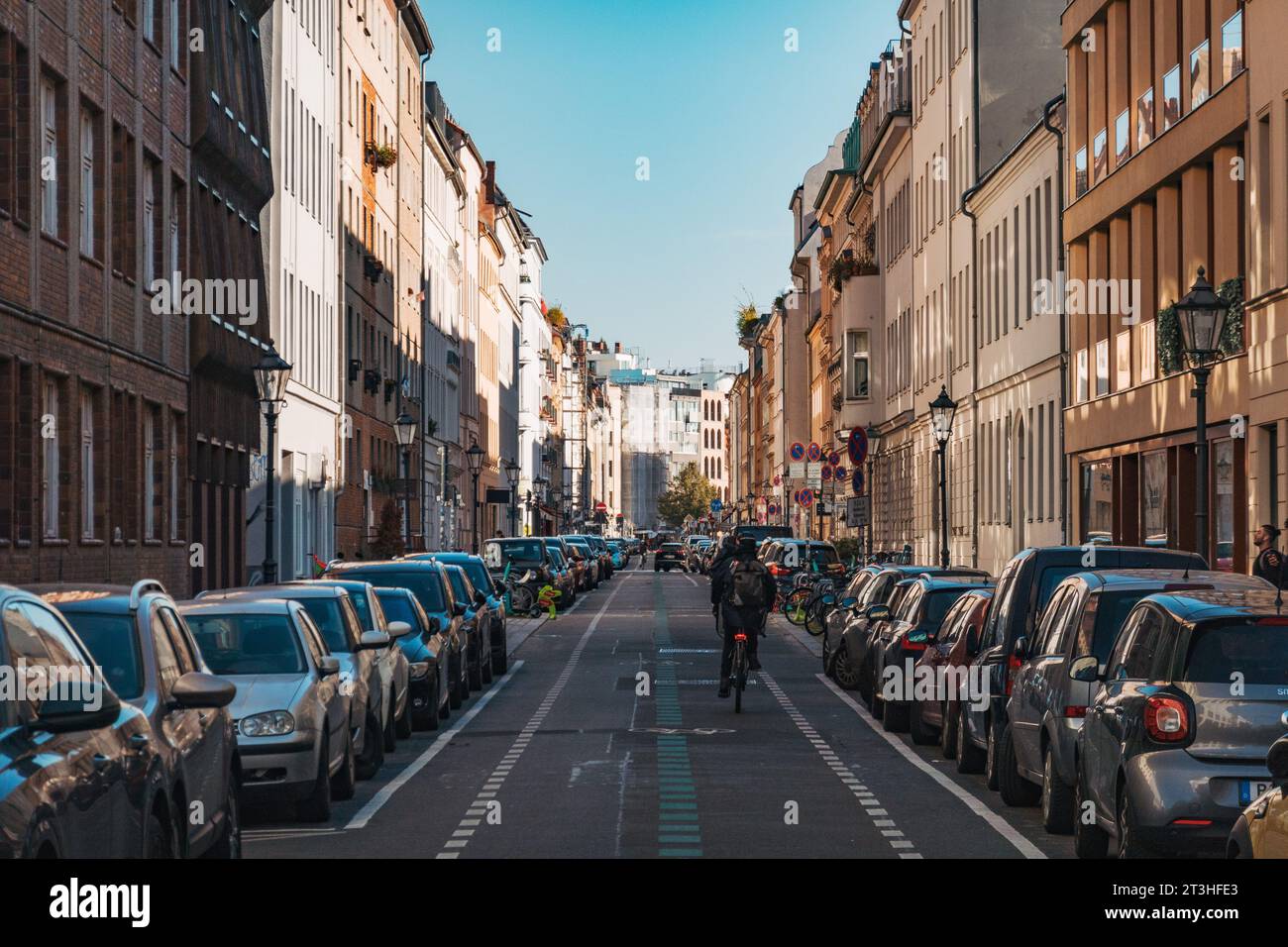 Berliners bicycle and scooter down Linienstraße, a residential street in Berlin, Germany Stock Photo