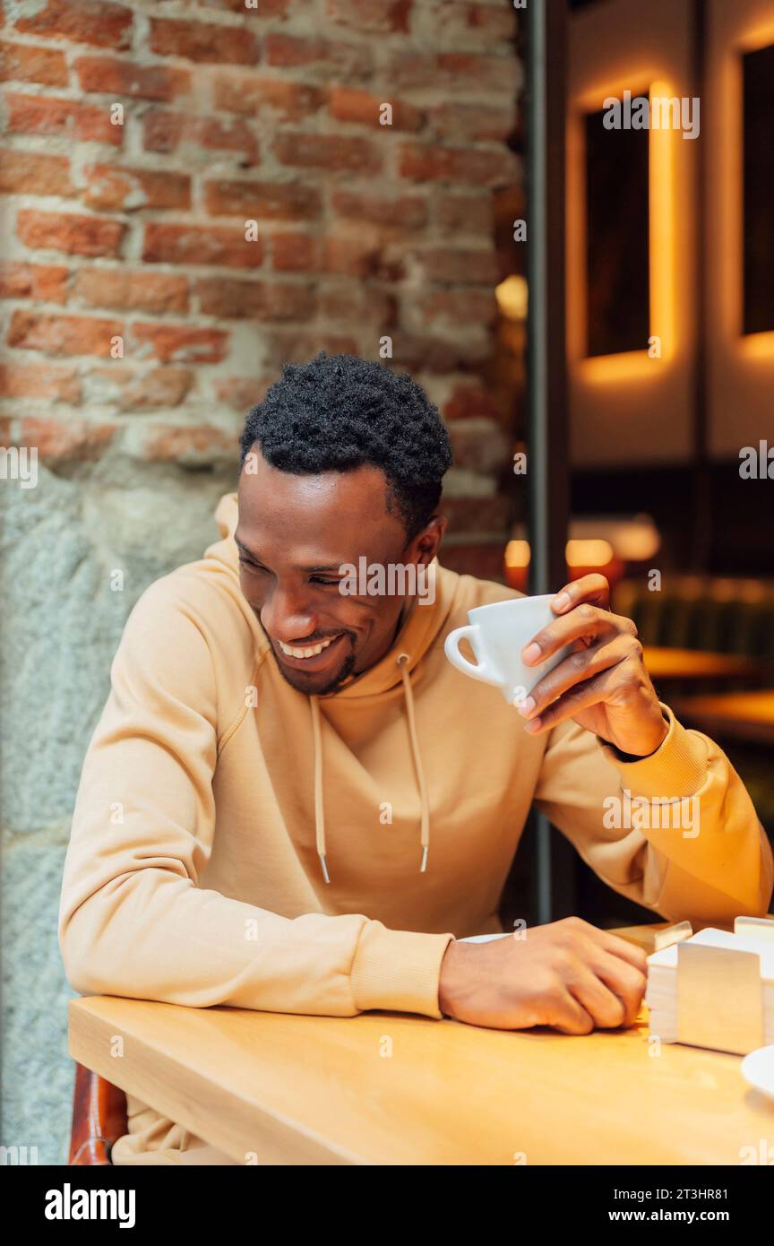 African American man smiling while drinking coffee Stock Photo