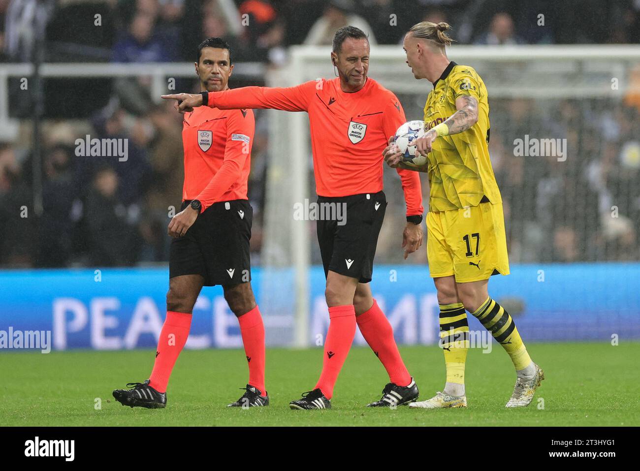Newcastle, UK. 25th Oct, 2023. Marius Wolf #17 of Borussia Dortmund and referee, Artur Dias Soares speak as they leave the field for half time during the UEFA Champions League match Newcastle United vs Borussia Dortmund at St. James's Park, Newcastle, United Kingdom, 25th October 2023 (Photo by Mark Cosgrove/News Images) Credit: News Images LTD/Alamy Live News Stock Photo