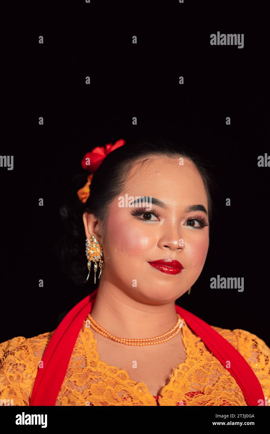 Sundanese woman wearing a short dress and traditional yellow dress with ...