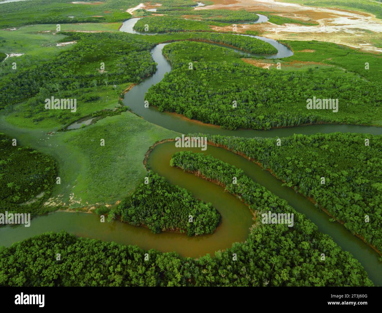 An aerial view of a river flowing through a green landscape Stock Photo ...