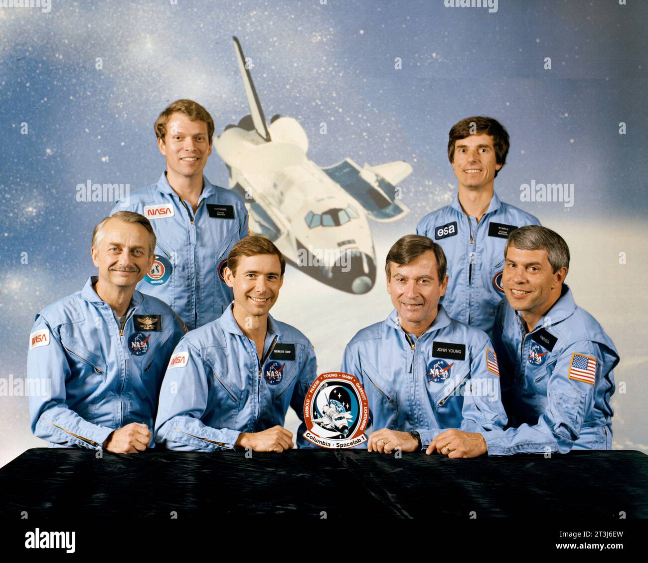 STS-9 crew. Seated from left to right are Owen Garriott, Mission Specialist; Brewster Shaw, Pilot; John Young, Commander; and Robert Parker, Mission Specialist. Standing from left to right are Byron Lichtenberg and Ulf Merbold, payload specialists. STS-9 was Space Shuttle Columbia's second operational mission. Stock Photo