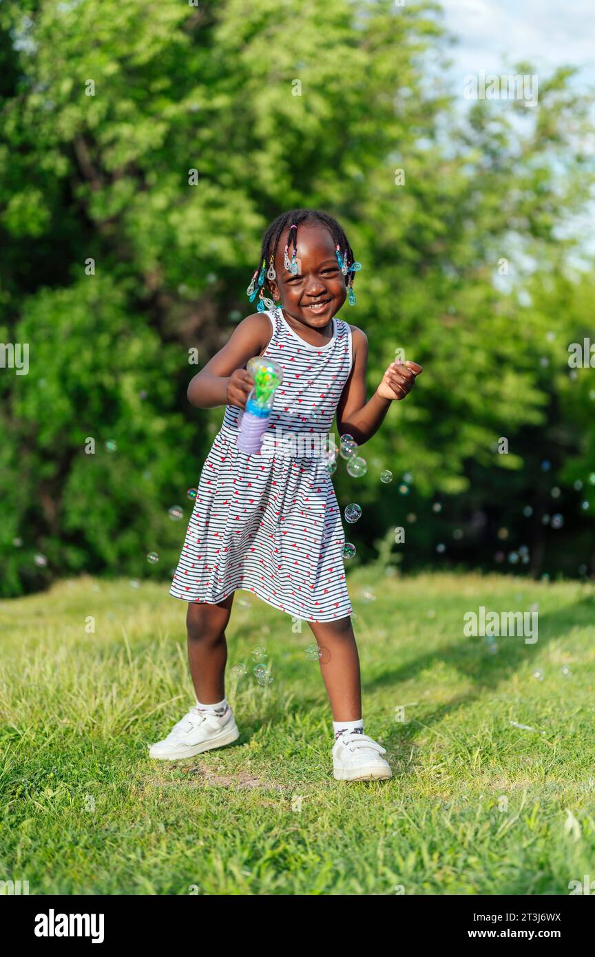 Girl shooting a bubble gun Stock Photo Alamy
