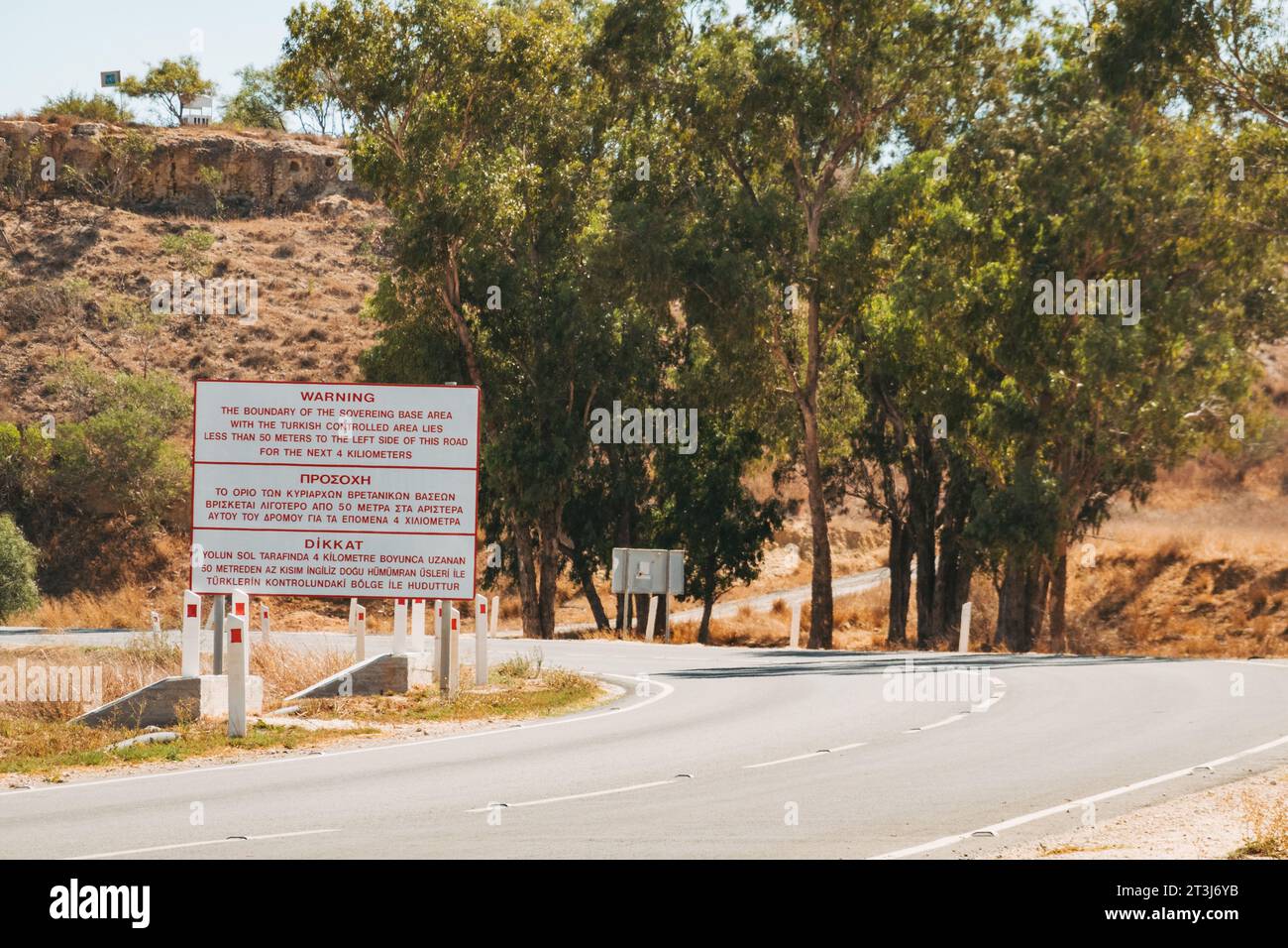 a multi-lingual sign warns the British-controlled Sovereign Base Area ends and the Turkish controlled area begins, in Cyprus Stock Photo