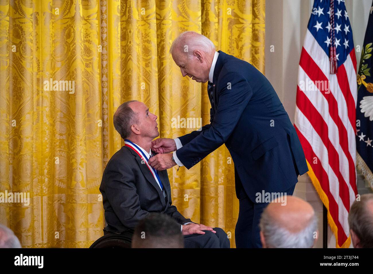 Washington, United States. 24th Oct, 2023. U.S President Joe Biden, center, presents the National Medal of Technology and Innovation to Dr. Rory Cooper, left, during a ceremony in the East Room of the White House, October 24, 2023 in Washington, DC Credit: Christopher Kaufmann/U.S. Army Photo/Alamy Live News Stock Photo