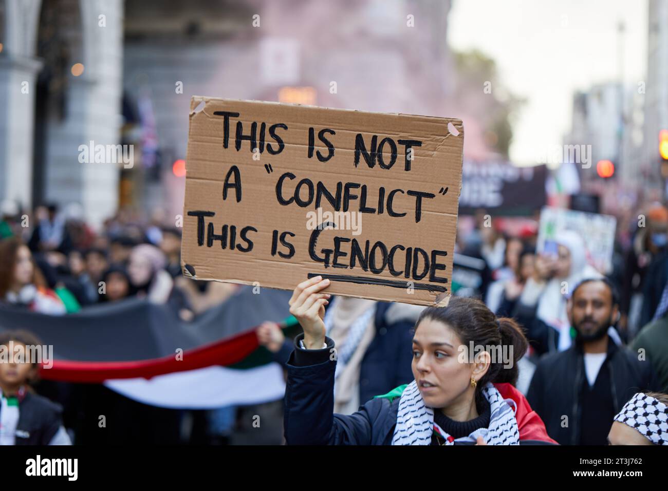 London, U.K. - 21 Oct 2023.: A protestor holds up a 'This is Genocide' placard during a National March for Palestine, organised by the Palestine Solidarity Campaign. Stock Photo