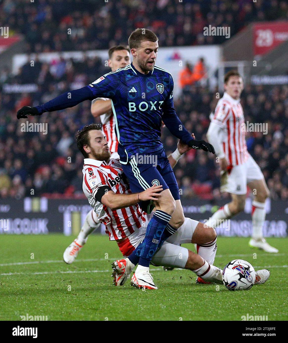 Leeds United's Patrick Bamford brought down by Stoke City's Ben Pearson resulting in a penalty to Leeds during the Sky Bet Championship match at the bet365 Stadium, Stoke-on-Trent. Picture date: Wednesday October 25, 2023. Stock Photo