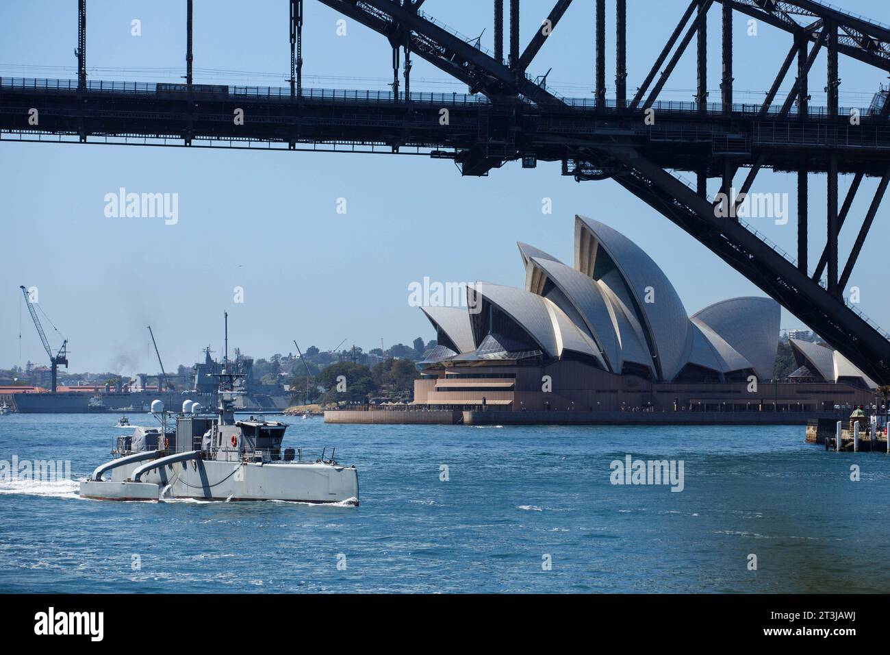 Sydney, Australia. 24th Oct, 2023. The U.S Navy unmanned surface vessel USV Sea Hunter transits underneath the Sydney Harbor bridge as it passes the Sydney Opera House during a scheduled port visit, October 24, 2023 in Sydney, NSW, Australia. Credit: ESN Pierson Hawkins/US Army/Alamy Live News Stock Photo