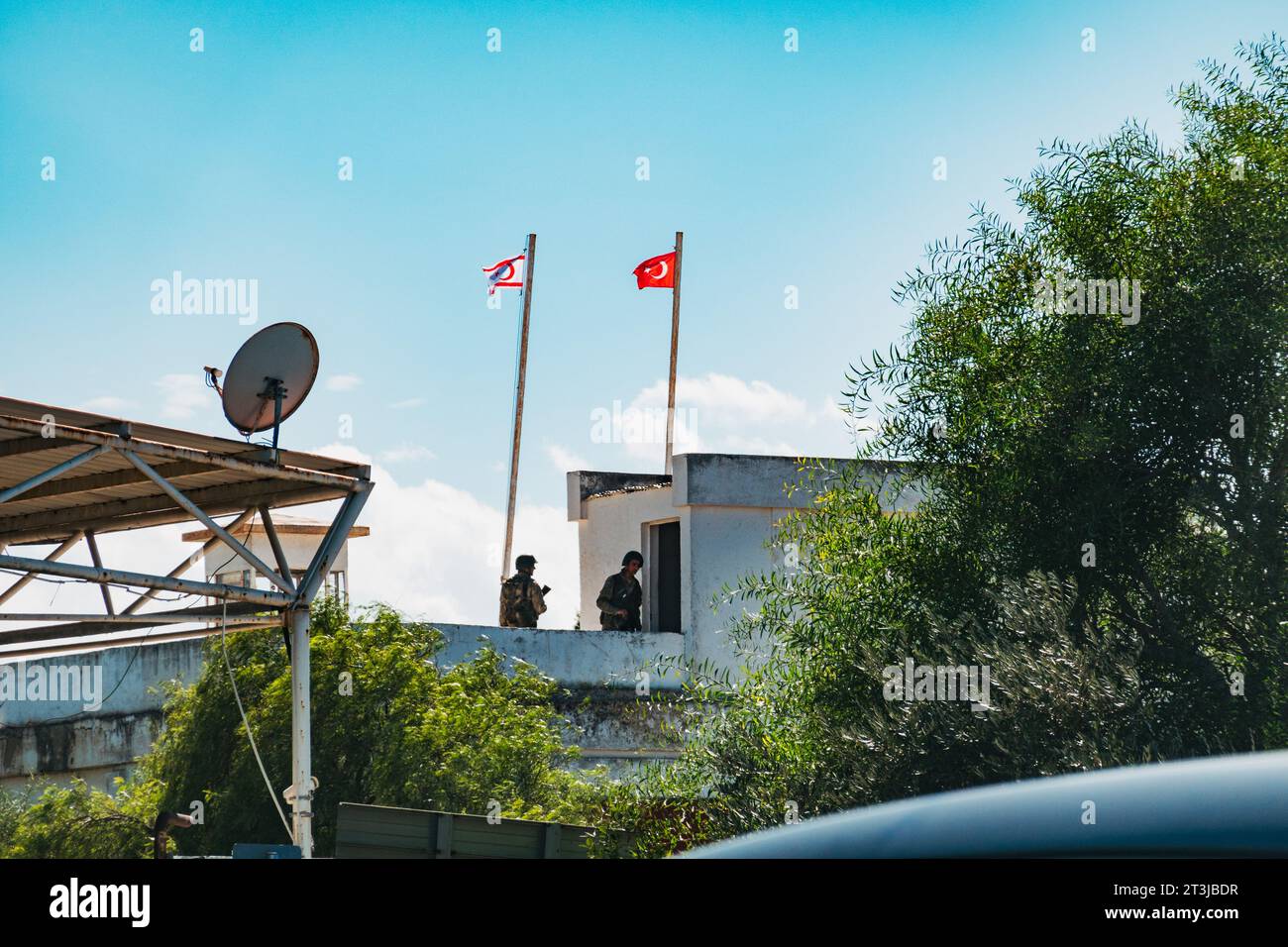 soldiers man a watchtower with Turkish and Northern Cypriot flags flying at a border crossing in North Nicosia, Cyprus Stock Photo