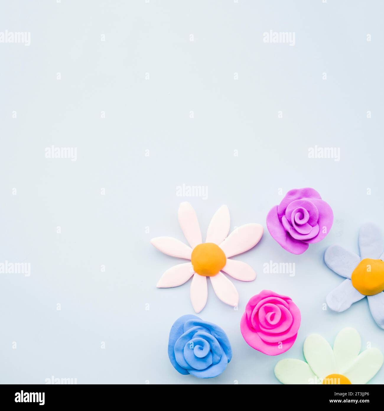 Different type clay flowers gray background Stock Photo