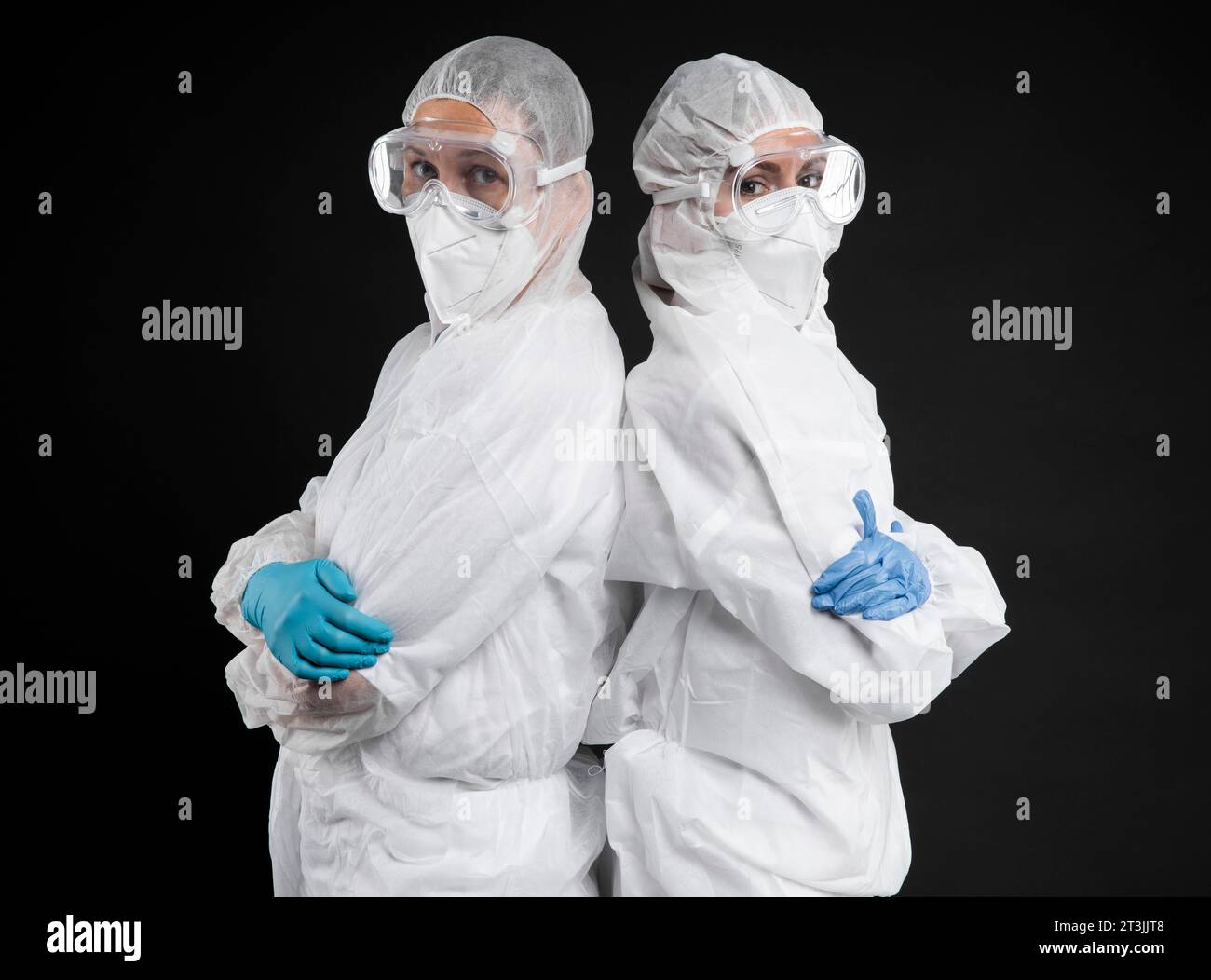 Doctors posing while wearing protective wear Stock Photo