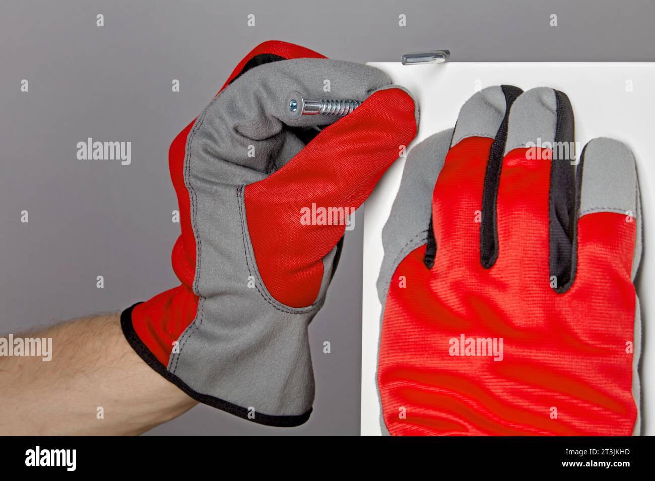 Furniture assembly manufacturing. Driving a furniture screw into a wood