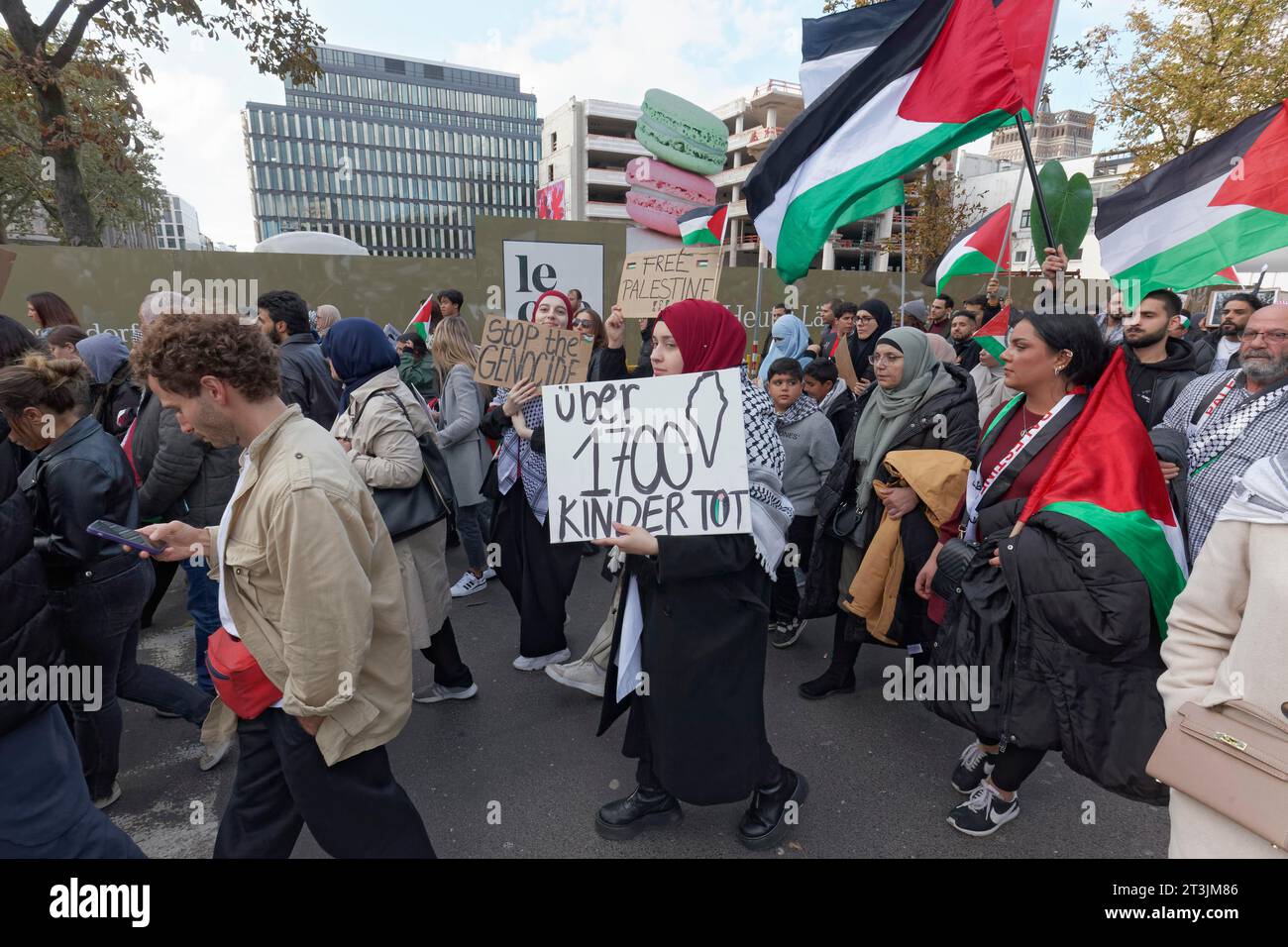 Demo participant with plaque Children dead, pro-Palestinian rally to condemn war crimes against civilians in Gaza on 21.10.2023 in Duesseldorf, North Stock Photo
