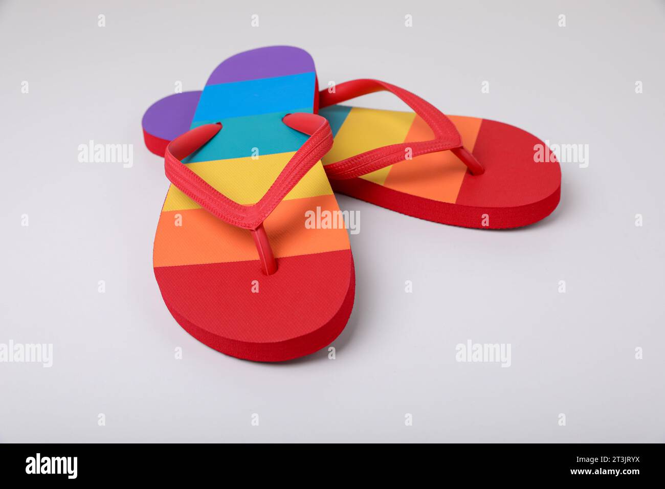 Stylish rainbow flip flops on white background Stock Photo - Alamy