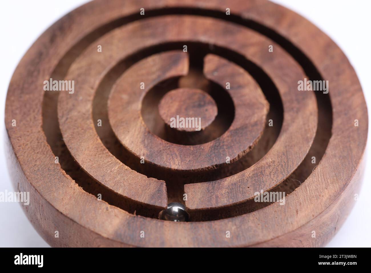 Wooden toy maze with metal ball on white background, closeup Stock Photo