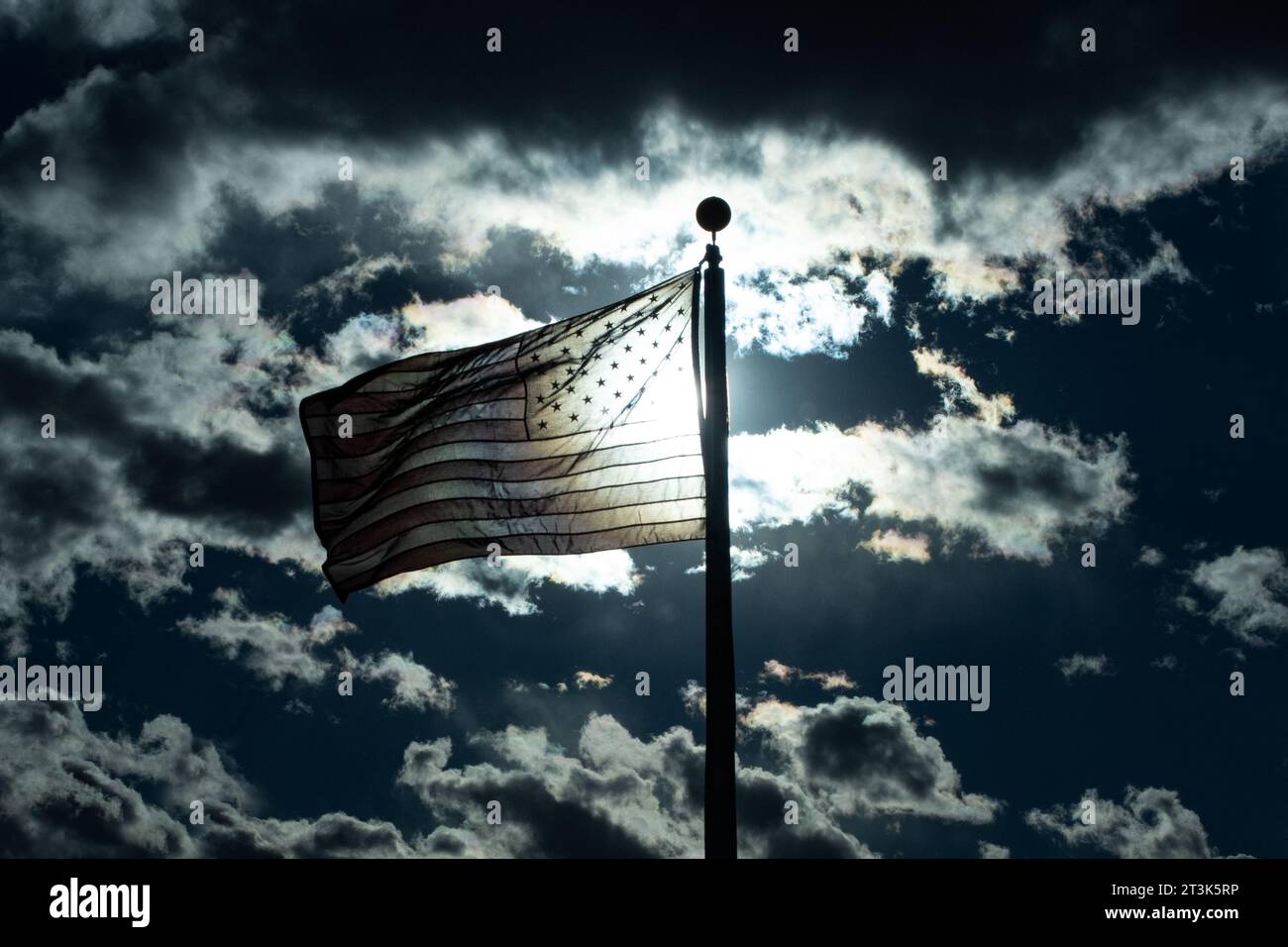 American flag flying proudly among the clouds proud and free our national emblem.  Star Spangled Banner Stock Photo