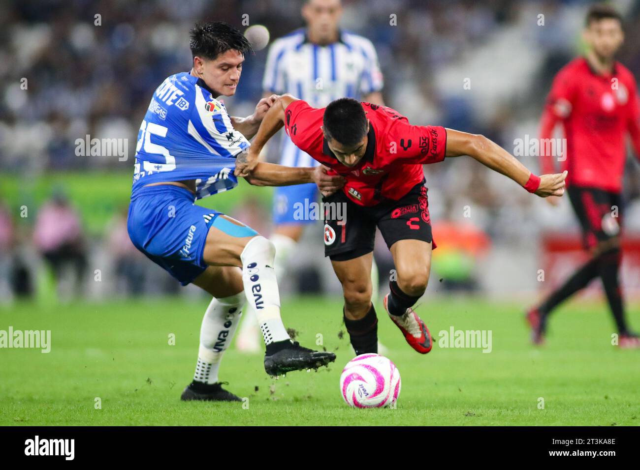 Monterrey, Mexico. 25th Oct, 2023. October 25th 2023, Estádio BBVA, Monterrey, Mexico: Liga BBVA MX postponed 4th round match between Monterrey Rayados and Club Tijuana Xolos. #7 Midfielder Club Tijuana, Alejandro Martinez getting past #25 Midfielder Rayados, Jonathan González Mandatory Credit: Toby Tande/PXImages Credit: Px Images/Alamy Live News Stock Photo