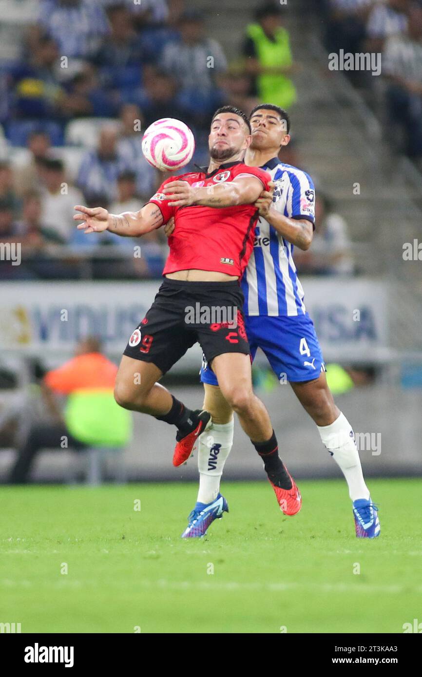 Monterrey, Mexico. 25th Oct, 2023. October 25th 2023, Estádio BBVA, Monterrey, Mexico: Liga BBVA MX postponed 4th round match between Monterrey Rayados and Club Tijuana Xolos. ##9 Forward Club Tijuana, Lucas Cavallini taking down the ball on the chest in front of #4 Defender Rayados, Víctor Guzmán Mandatory Credit: Toby Tande/PXImages Credit: Px Images/Alamy Live News Stock Photo