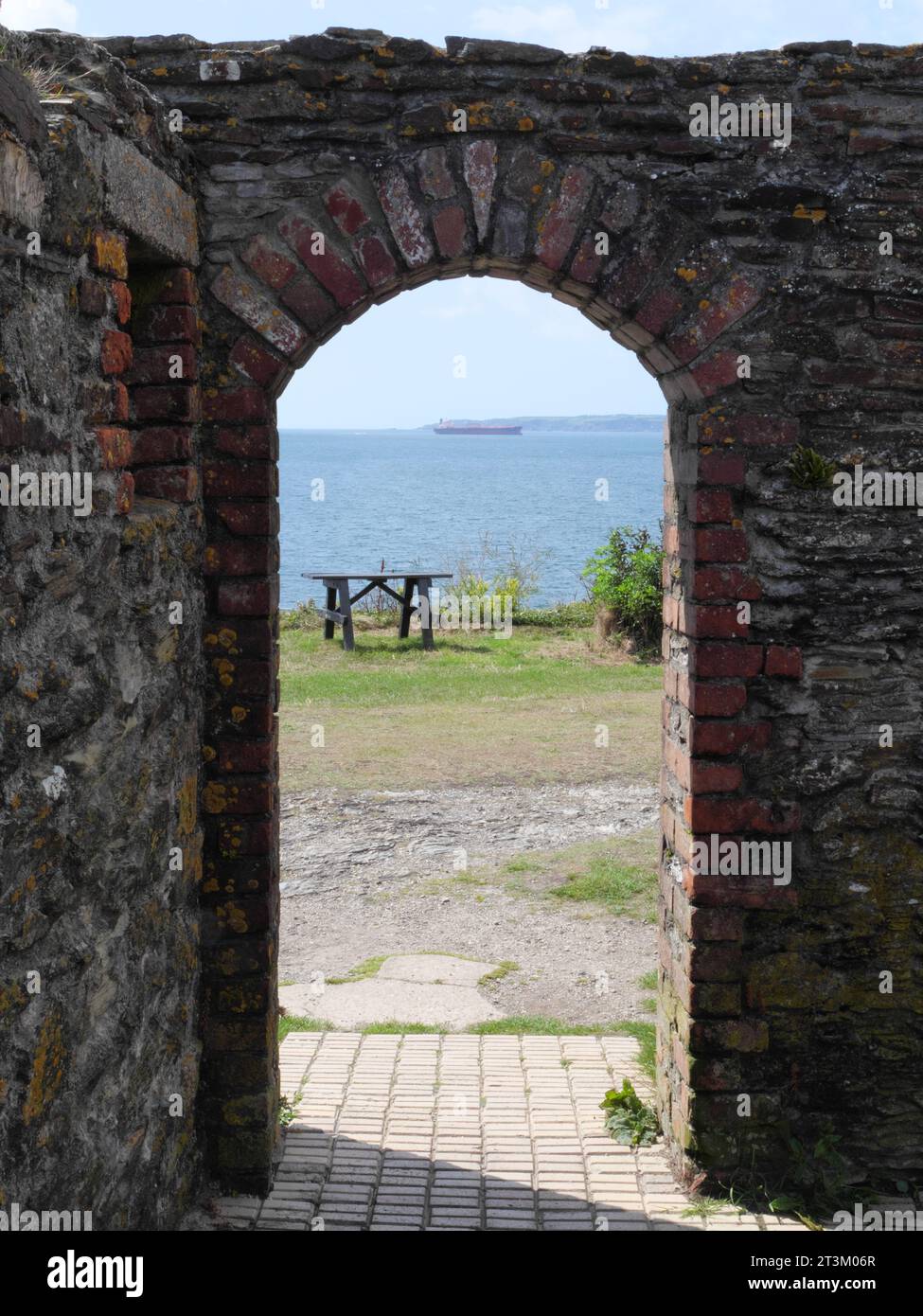 View of the horizon with sea through a round arch of a ruin below Pendennis Castle near Falmouth England Stock Photo