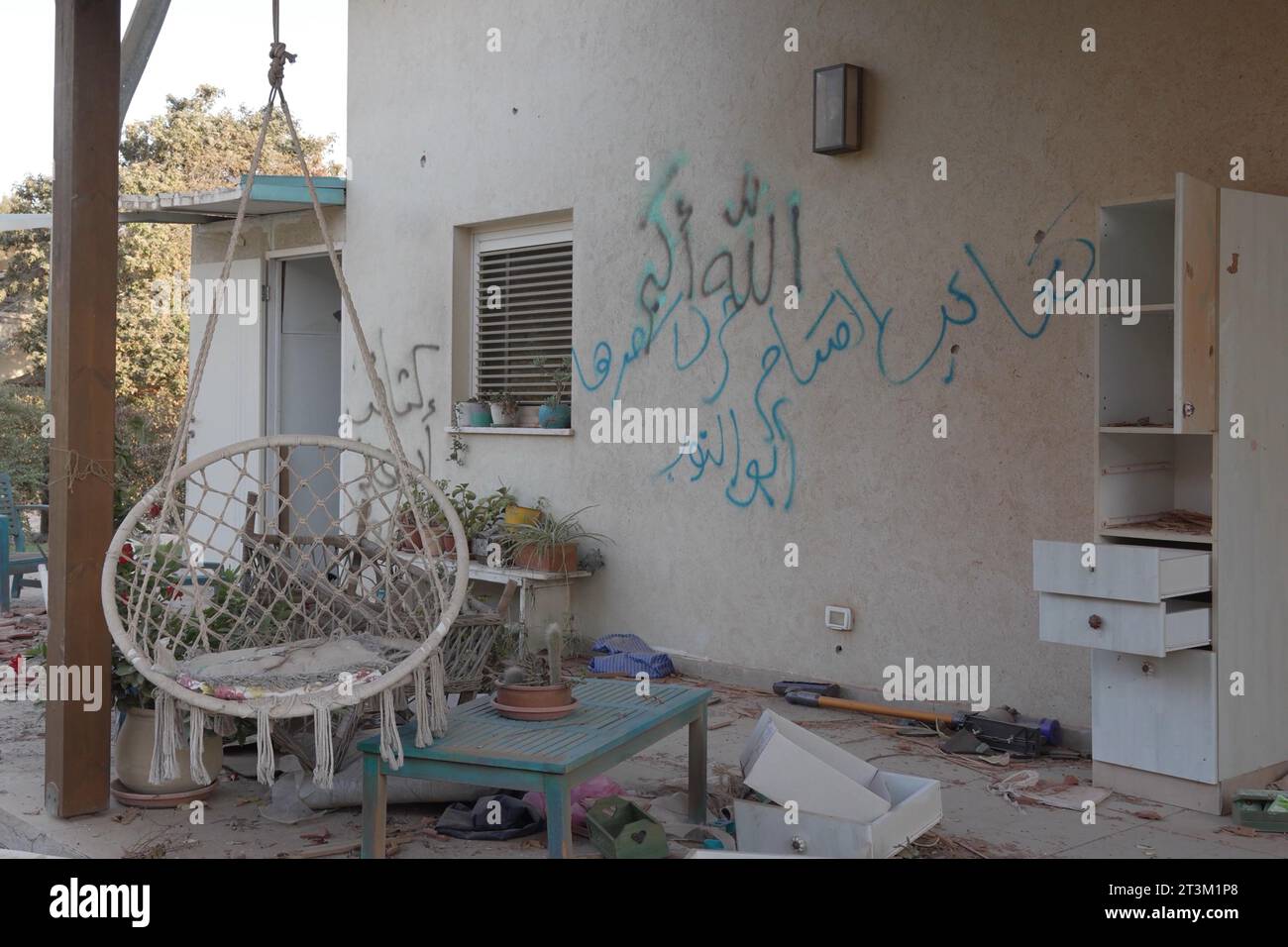 Writing in Arabic left by Palestinian militants outside a house during the October 7 attack by Palestinian Hamas militants in kibbutz Beeri near the border with Gaza stands on October 17, 2023 in Be'eri, Israel. In the wake of the Oct. 7 attacks by Hamas that left 1,400 dead and 200 kidnapped, Israel launched a sustained bombardment of the Gaza Strip and threatened a ground invasion to vanquish the militant group that governs the Palestinian territory. Stock Photo