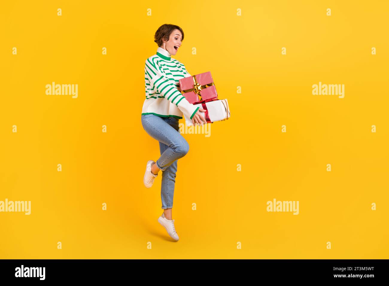 Full body size photo of young positive jump girl wear sweater hold pile ...
