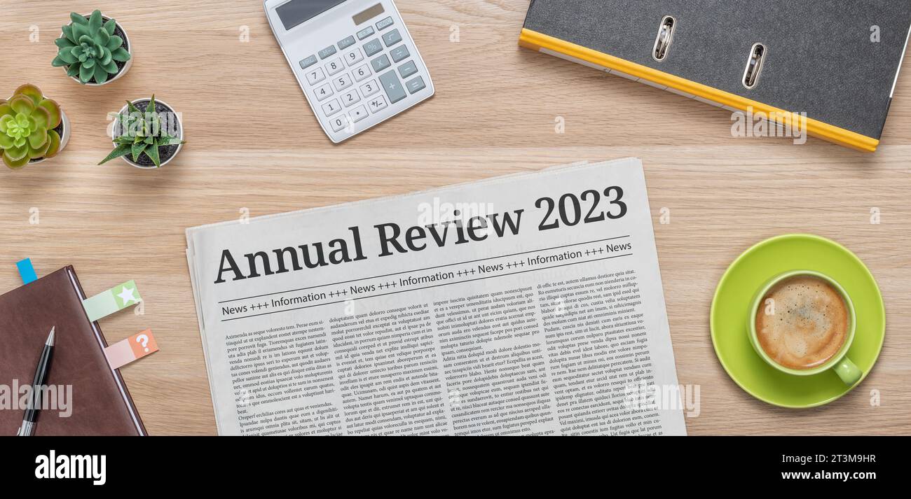 A newspaper on a desk with the headline Annual review 2023 Stock Photo