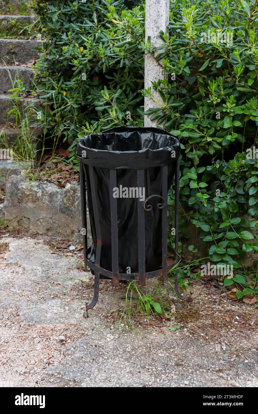 Outdoor metal trash can with plastic bag placed at the Acropolis of Rhodes for public use Stock Photo