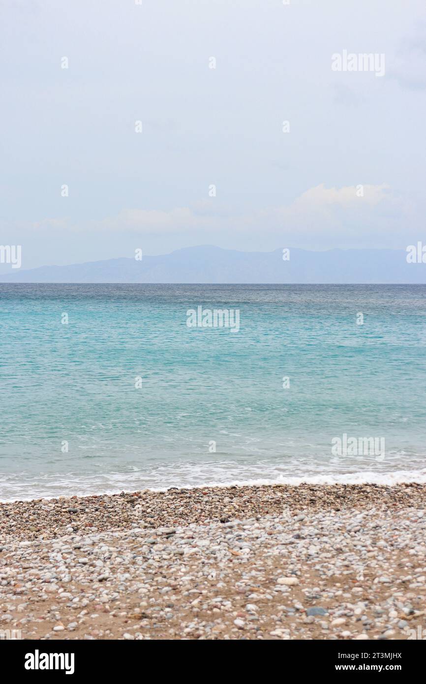 Clear water washing up on the shore at Paralia Ixia beach off Rhodes city Stock Photo