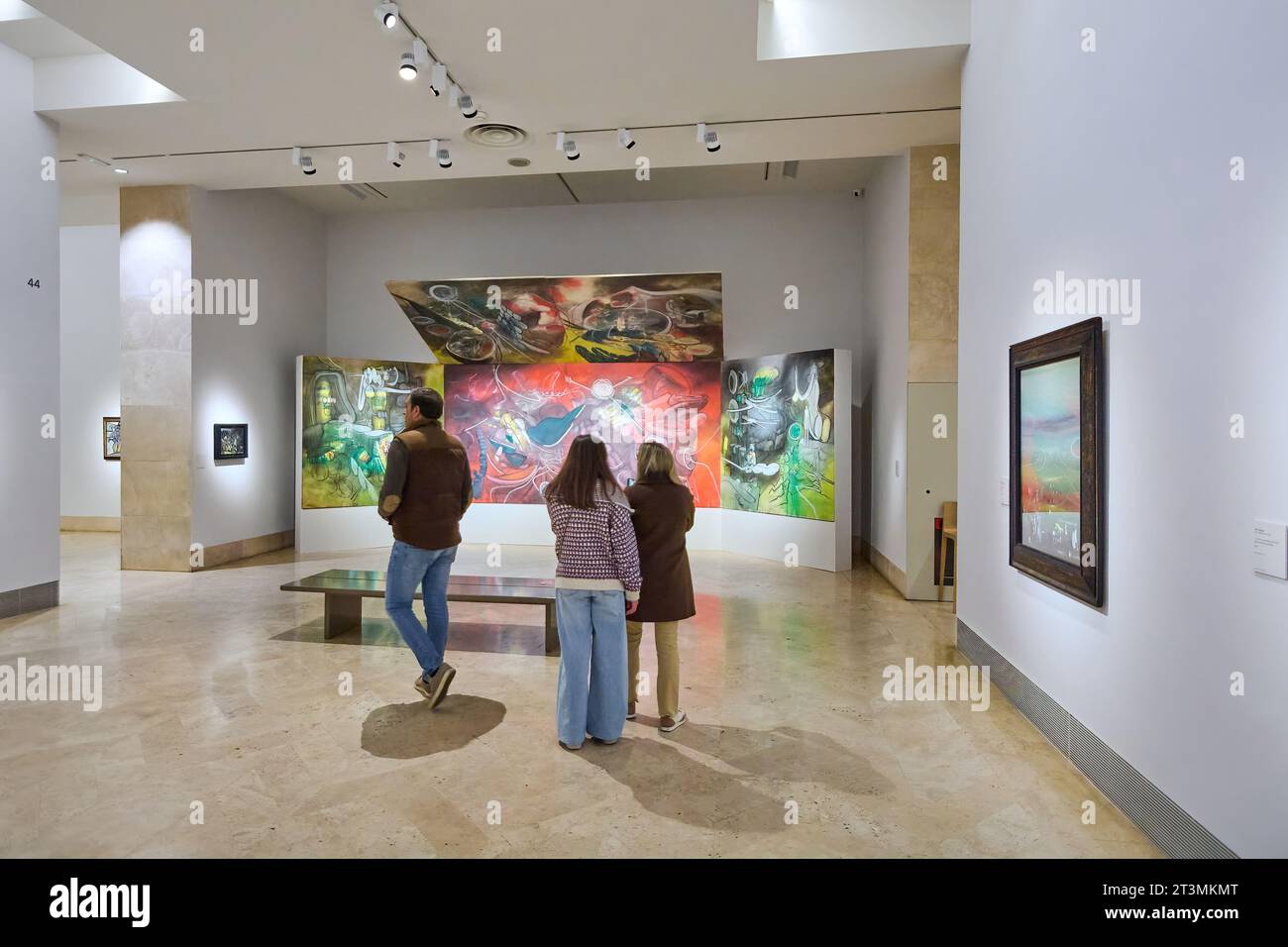 MADRID SPAIN - October 26, 2023: Group of people admiring an abstract painting in a brightly lit art gallery of the Thyssen Bornemisza national museum Stock Photo