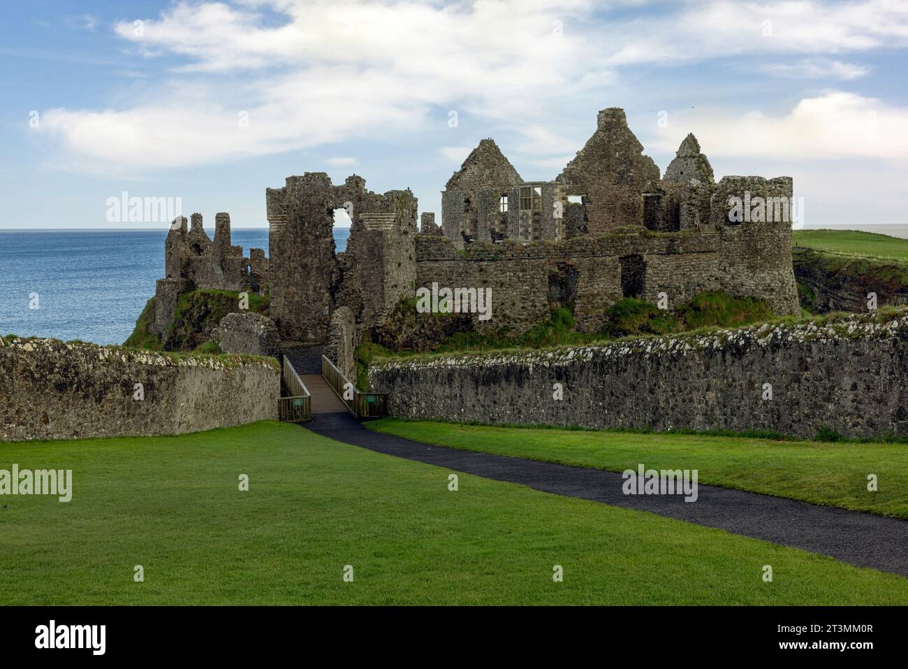 Dunluce Castle is a ruined medieval castle that is located on the Antrim Coast in Northern Ireland. Stock Photo