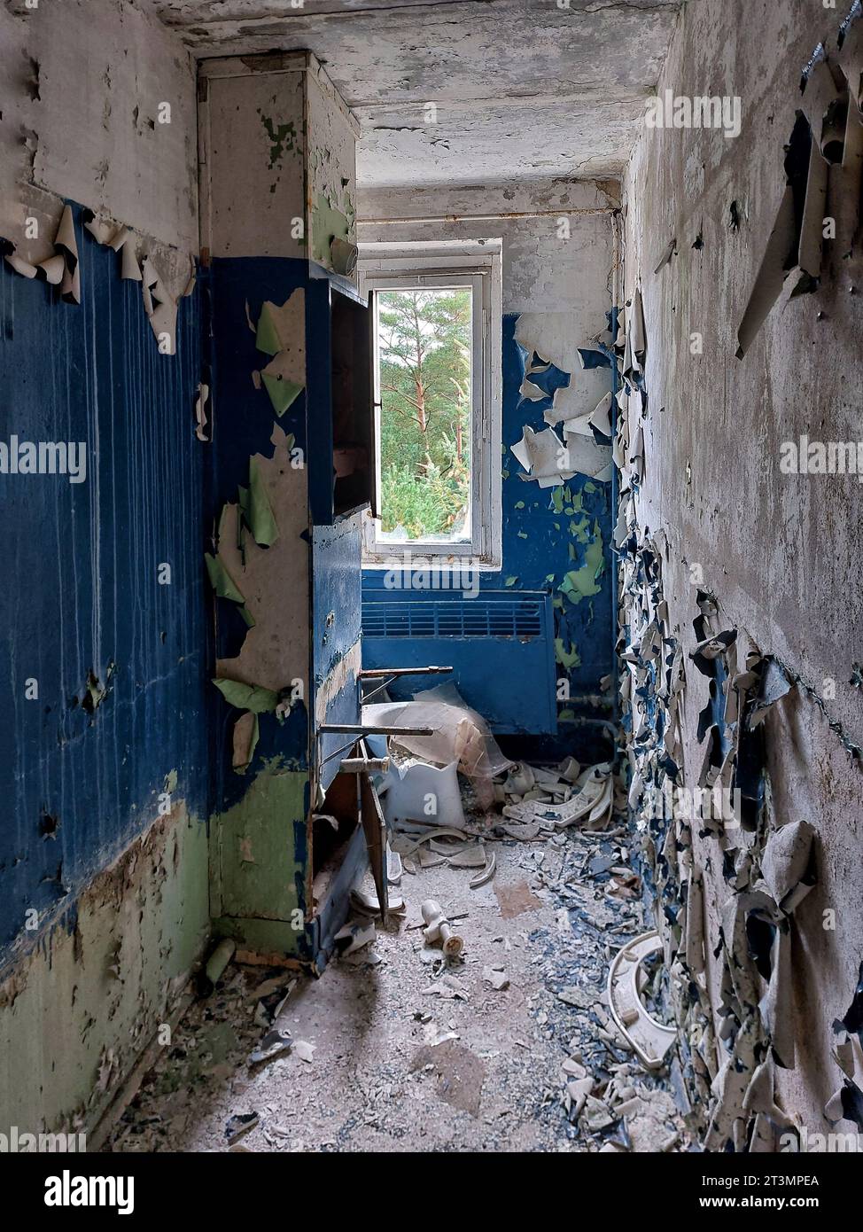 Ruins of bathroom with paint falling off the walls. Stock Photo