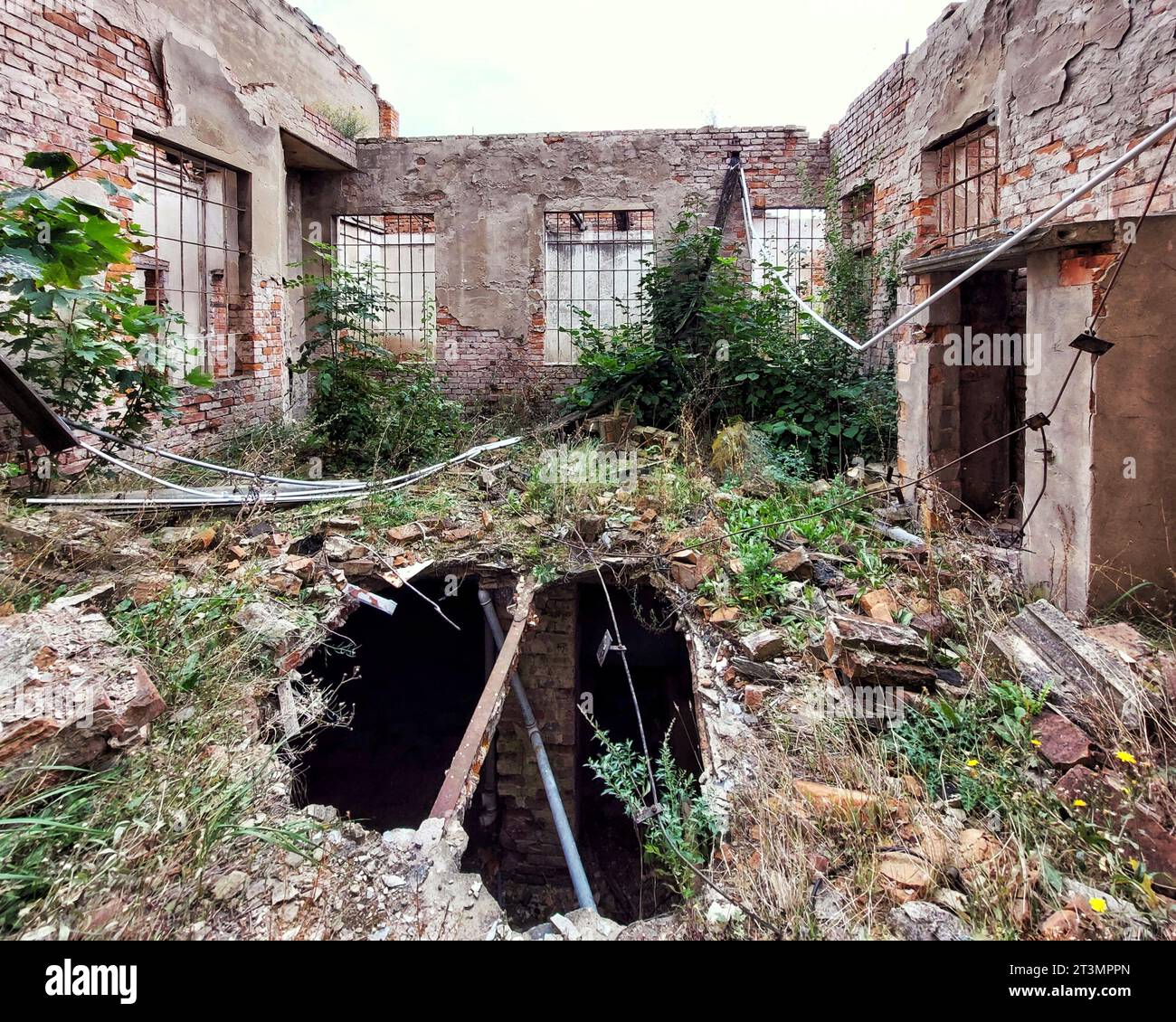 Hole on courtyard of an abandoned building. Stock Photo