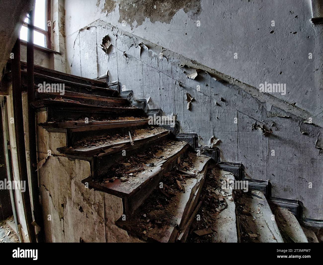Noisy image of desolate staircase in an abandoned building. Stock Photo