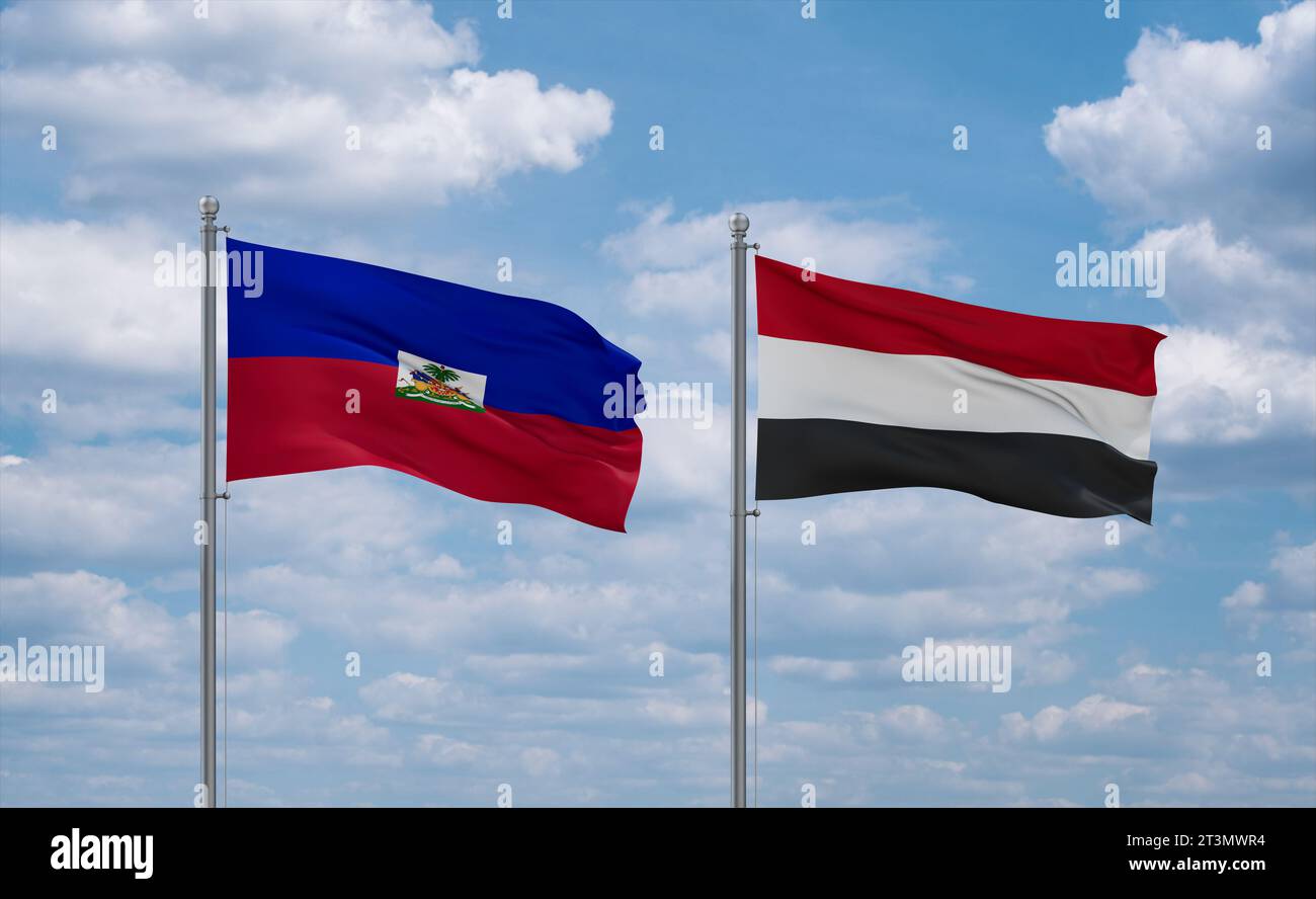 Yemen and Haiti flags waving together in the wind on blue cloudy sky, two country relationship concept Stock Photo