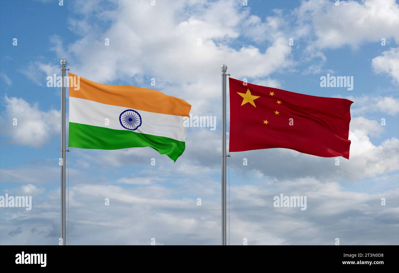 China and India flags waving together on blue cloudy sky, two country relationship concept Stock Photo
