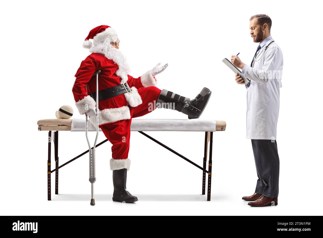 Santa claus with an injured leg talking to a male doctor and sitting on a therapy table isolated on white background Stock Photo