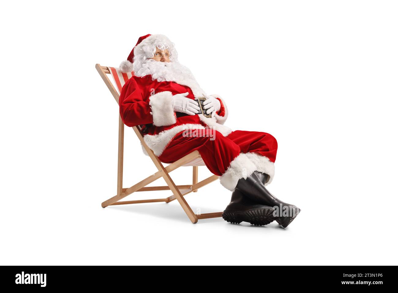 Santa claus sitting on a beach chair and relaxing isolated on white background Stock Photo