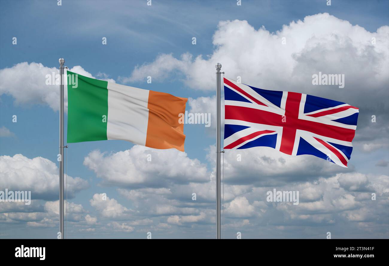 United Kingdom and Ireland flags waving together in the wind on blue ...