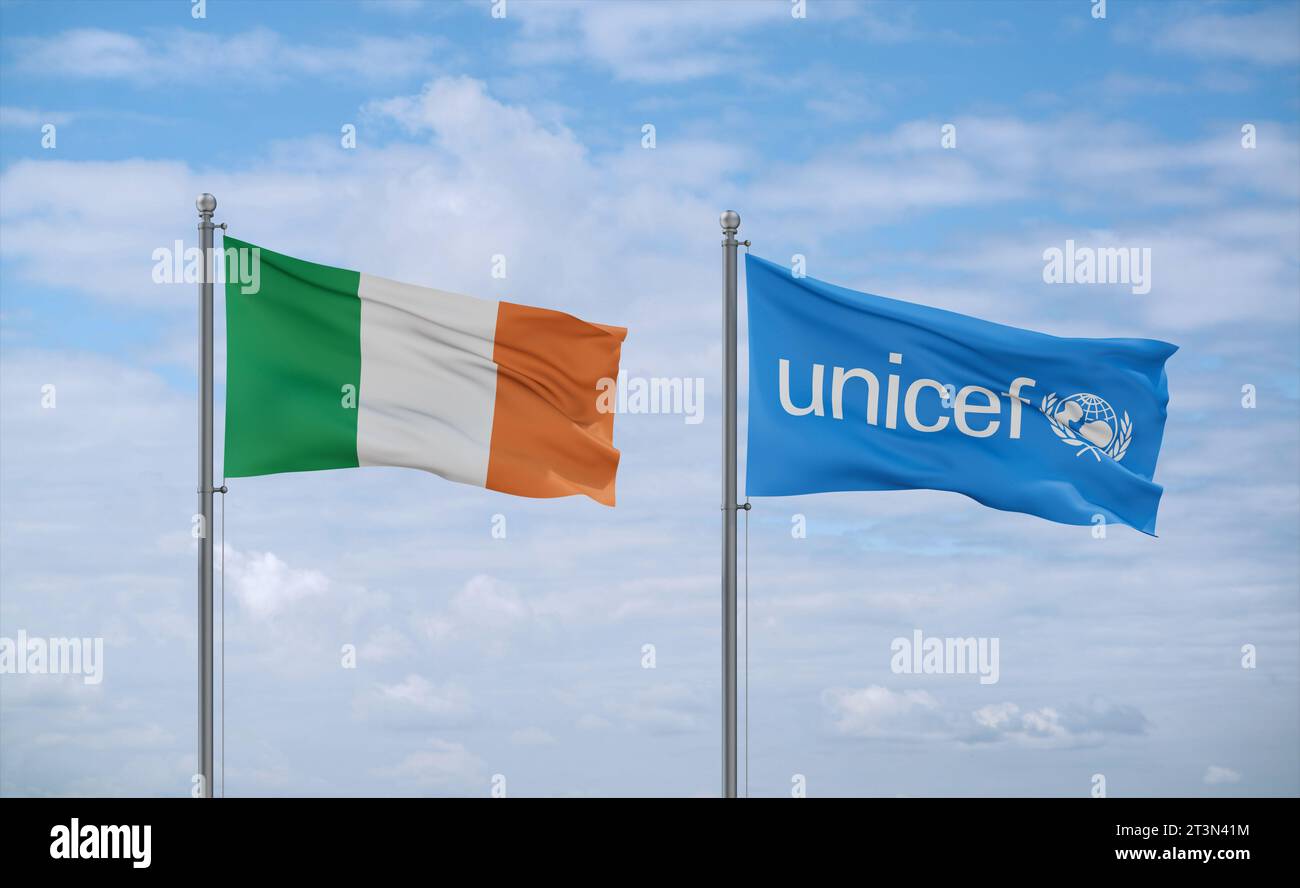 UNICEF and Ireland flags waving together in the wind on blue cloudy sky, relationship concept Stock Photo