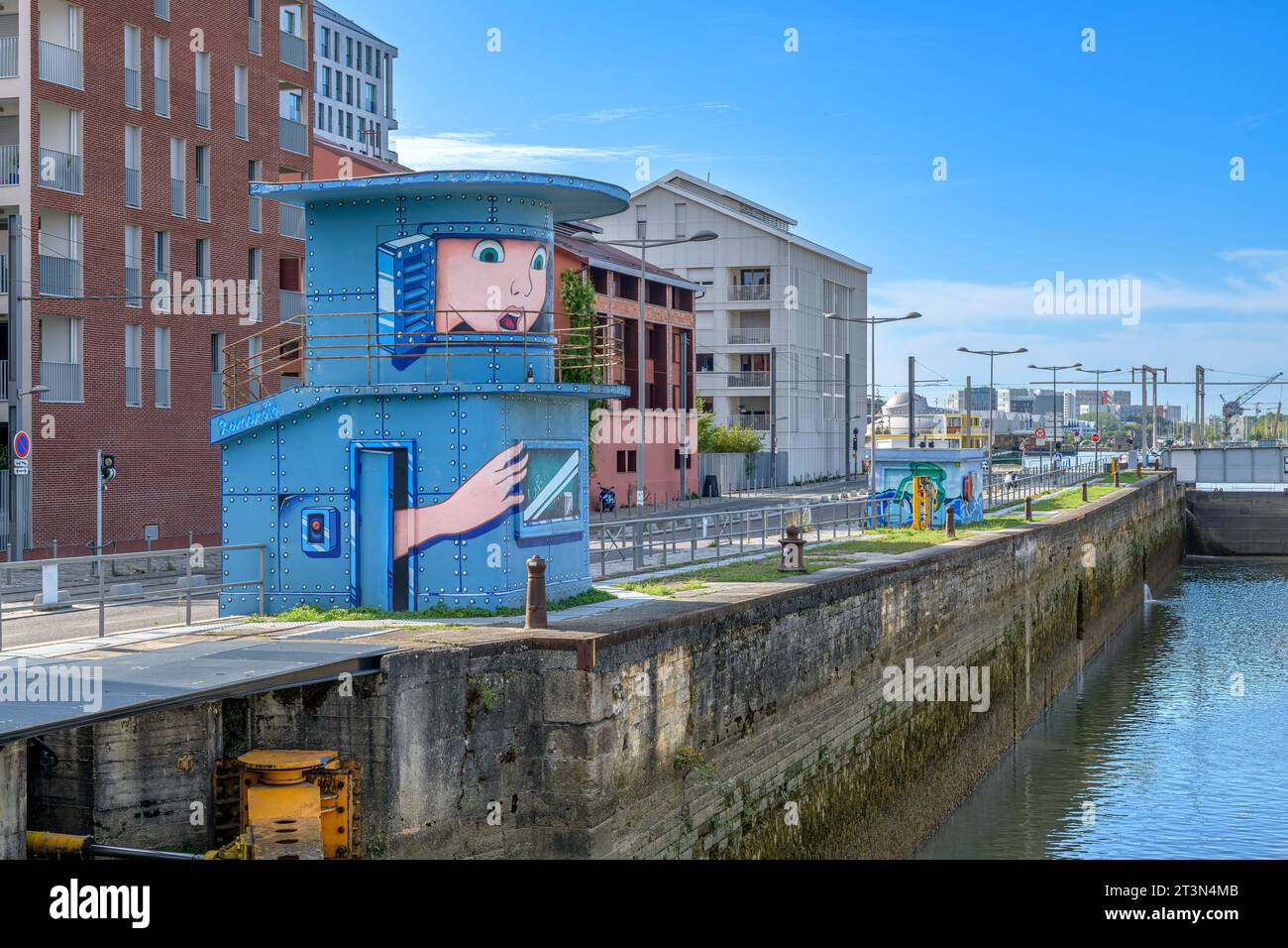 Mural called Guérite (Be Healed) by Landry Muñoz pseudonim: LANDROÏD. The artwork of a girl trapped inside a redundant control tower for flood locks. Stock Photo
