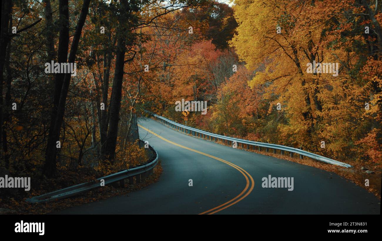 Scenic road surrounded by New England's fall foliage. Stock Photo