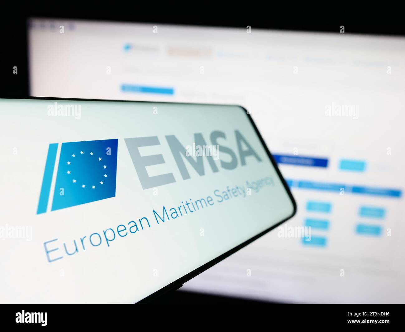 Smartphone with logo of EU institution European Maritime Safety Agency (EMSA) in front of website. Focus on center-left of phone display. Stock Photo