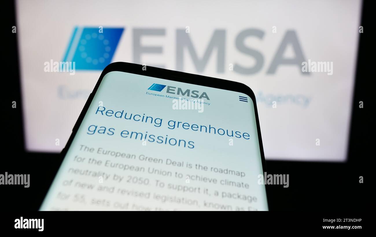 Mobile phone with website of EU institution European Maritime Safety Agency (EMSA) in front of logo. Focus on top-left of phone display. Stock Photo