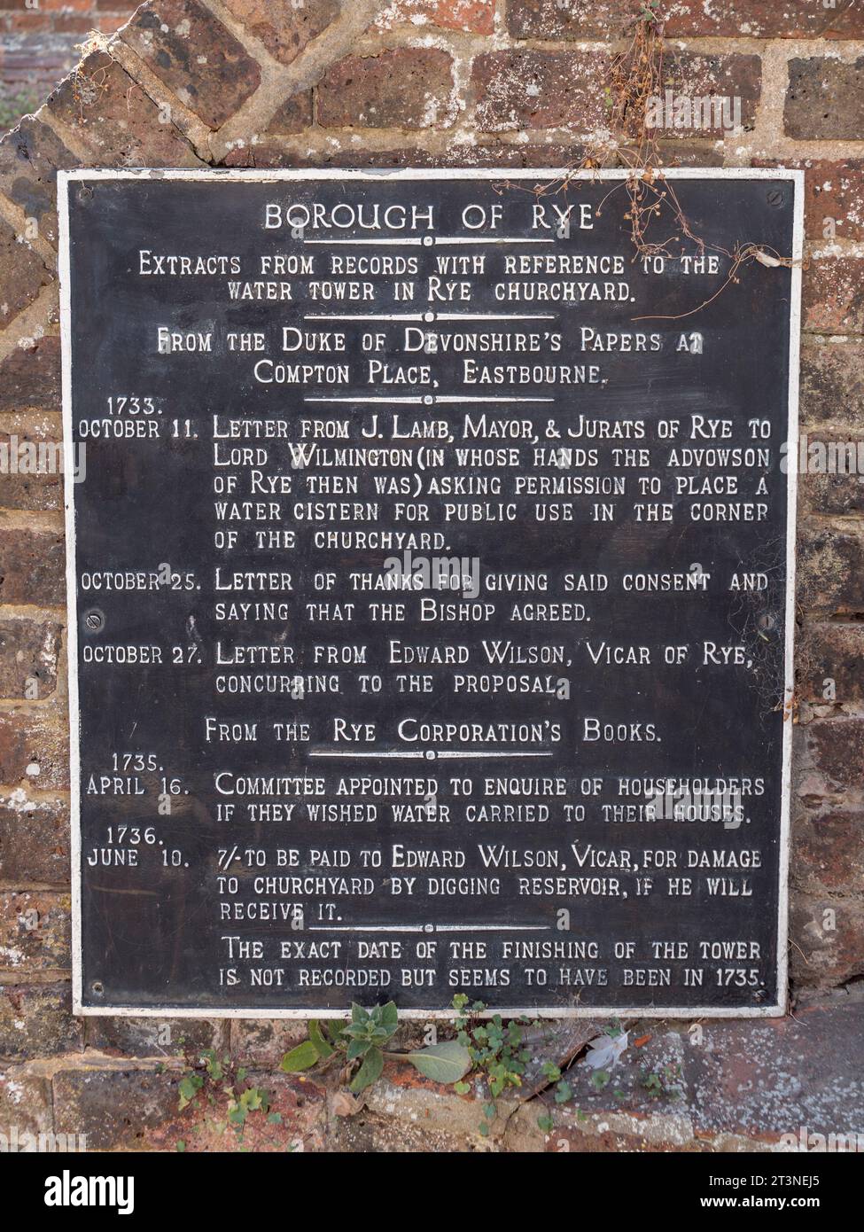 Plaque marking the water tower in the churchyard of the Church of Saint Mary, in Rye, East Sussex, UK. Stock Photo