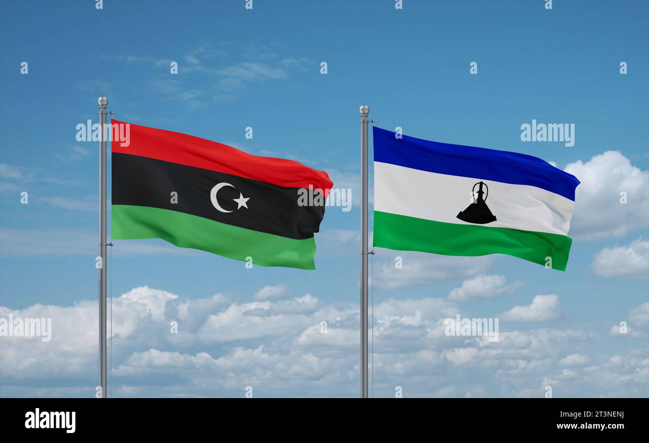 Lesotho and Libya flags waving together in the wind on blue cloudy sky ...