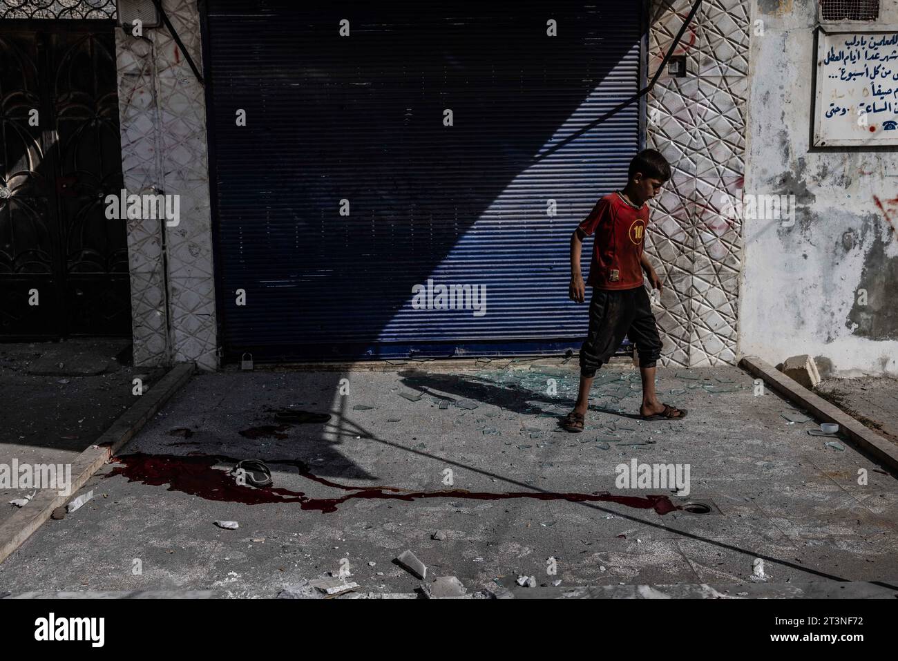 26 October 2023, Syria, Idlib: A child inspects the damage after a missile strike that targeted the city of Idlib by the Syrian regime. Two civilians were killed, and others were injured. Photo: Anas Alkharboutli/dpa Stock Photo