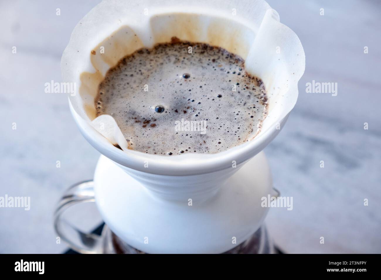 Alternative method of making coffee, funnel drip glasses with paper filter  and aeropress Stock Photo - Alamy