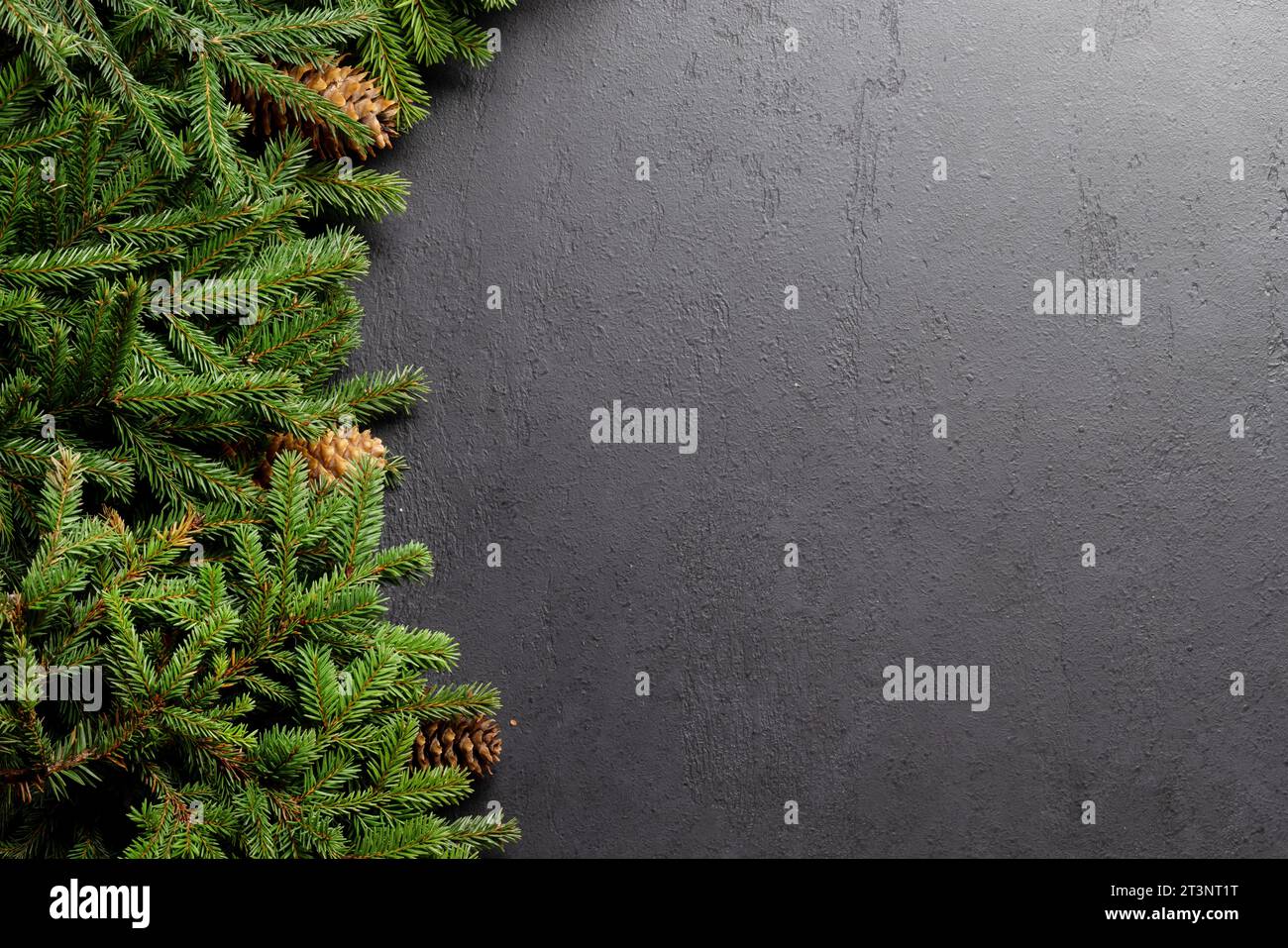Christmas fir tree branch frame over stone with space for greetings ...