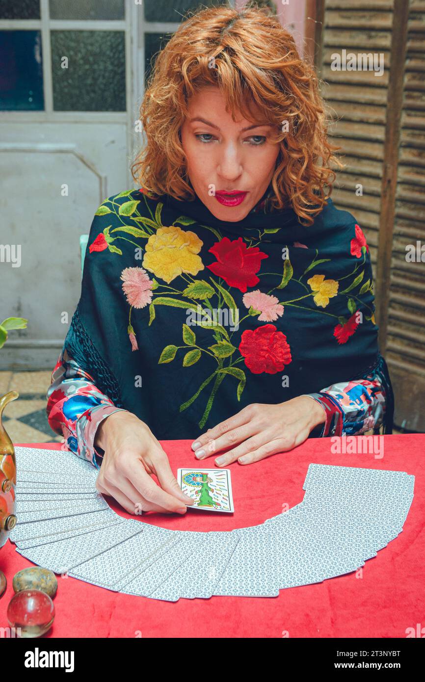 Vertical image of Latin tarot reader woman, elegant clothes and blonde