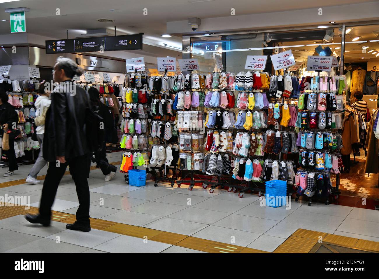 SEOUL, SOUTH KOREA - APRIL 5, 2023: People visit novelty sock store in Myeongdong Underground Shopping Center in underground walkways of Myeongdong St Stock Photo